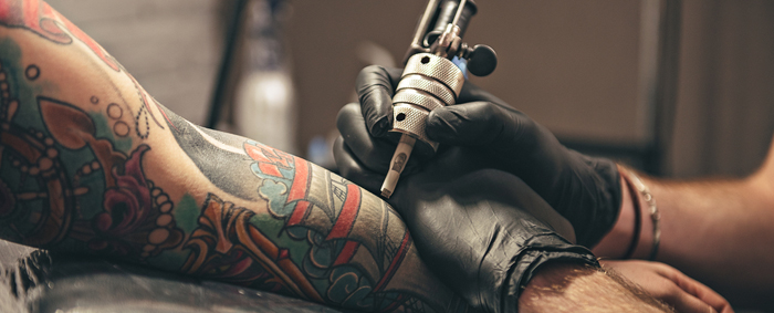 A traditional sleeve being tattooed