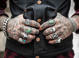 Heavily tattooed male hands